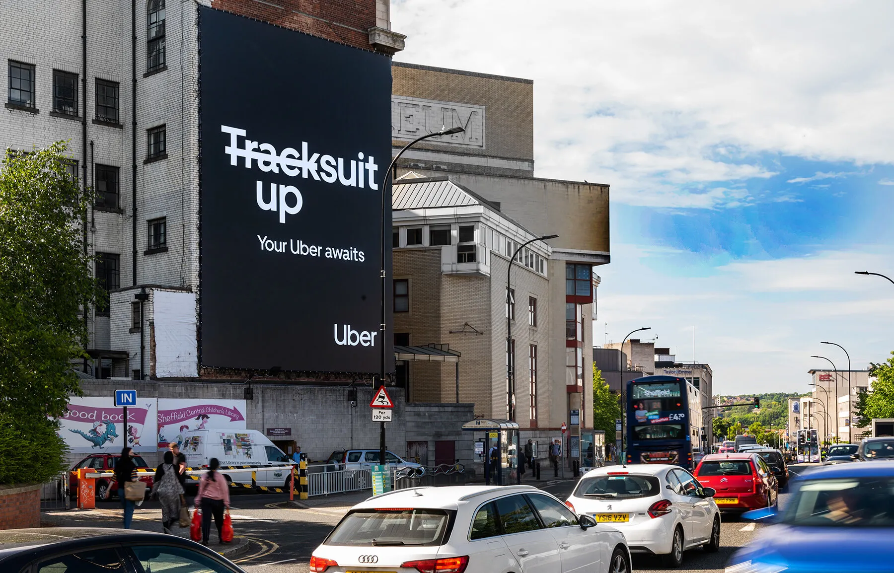 "tracksuit up" building wrap overlooking a busy Sheffield street