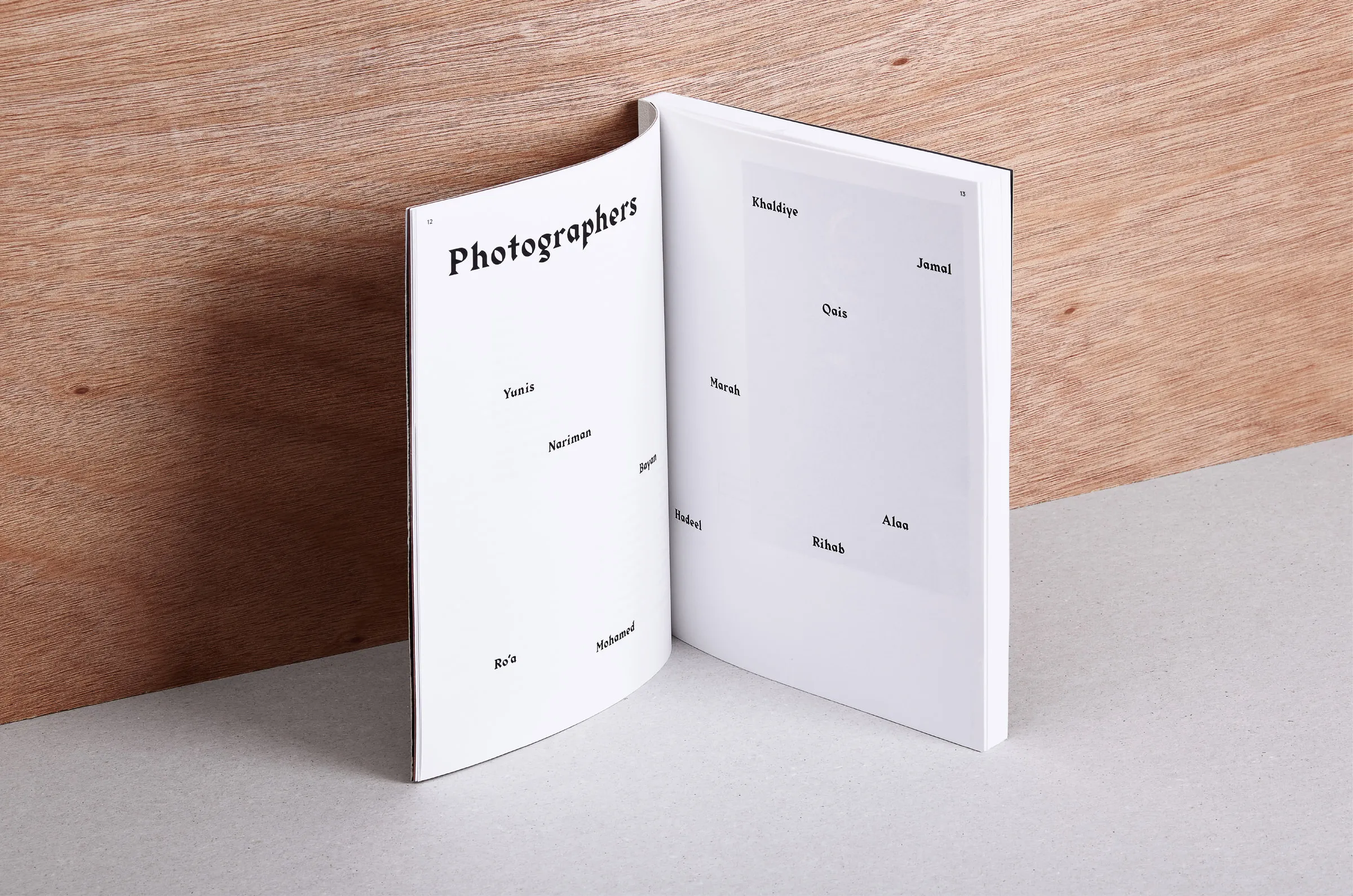 Exhibition book open on the Photographers page, listing the children by first name
