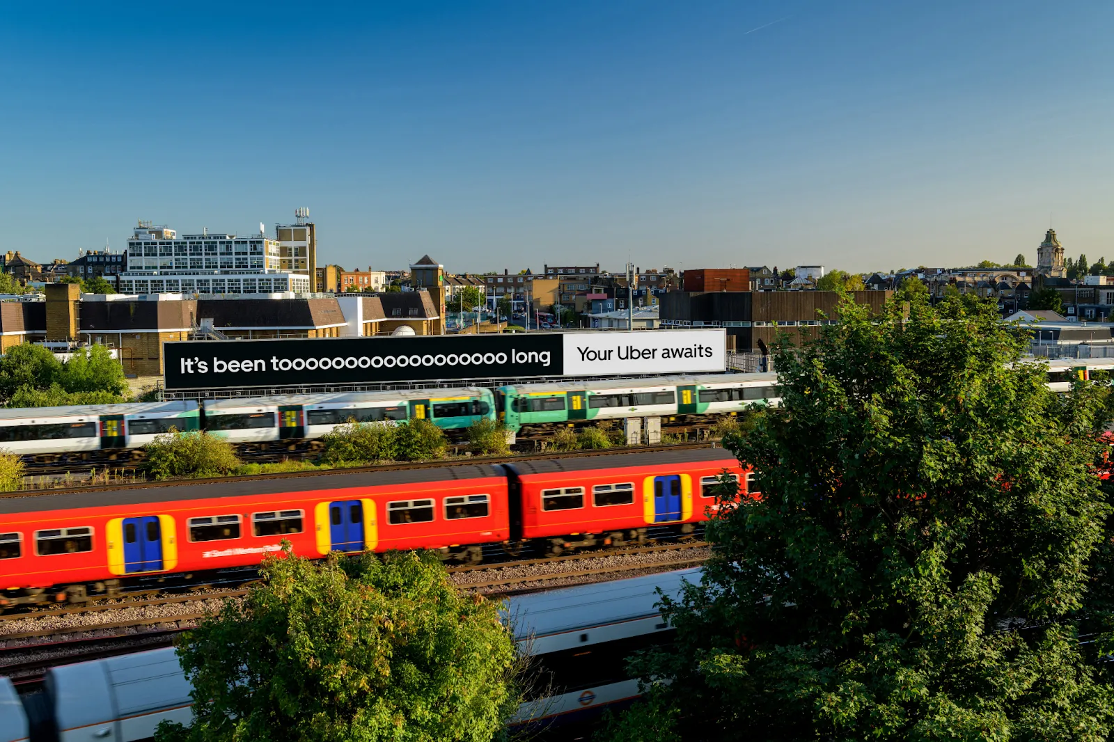 "it's been tooooo long" banner above a railway depot full of trains